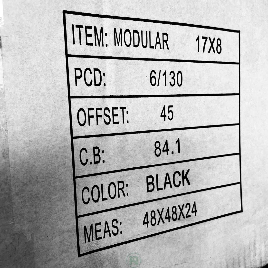 B&W phot of Wheel fitment info printed on the side of a plain white box