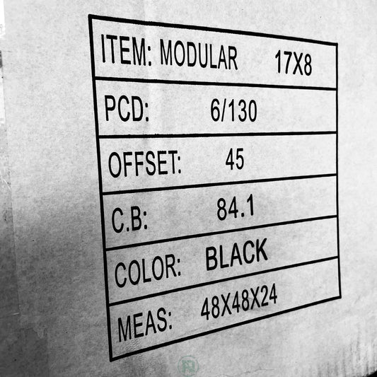 B&W phot of Wheel fitment info printed on the side of a plain white box