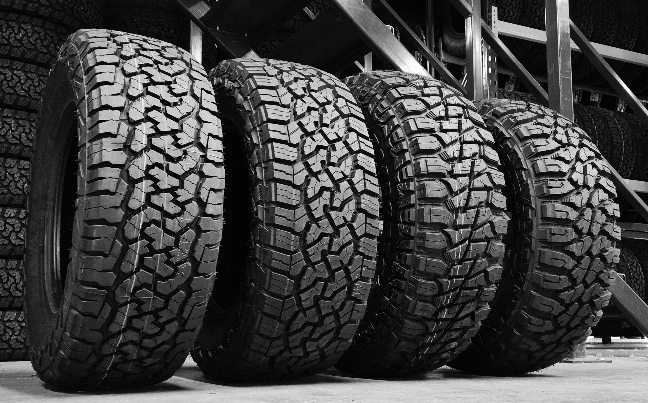 low angle B&W 4x Roadcruza 4x4 & offroad tyre line up in warehouse setting