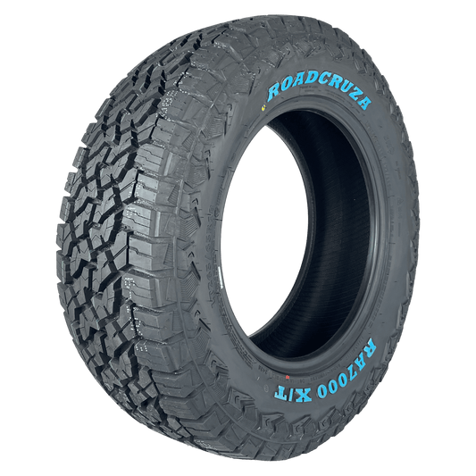 A single off-road tyre shown at a three-quarter angle on a solid white background, featuring the brand name ROADCRUZa and model name RA700 X/T white lettering on the sidewall.