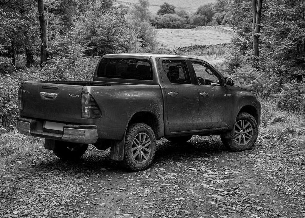B&W Toyota Hilux on a country lane image | roadcruza 4x4 tyres 